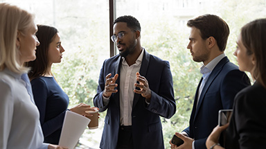 Professional Coach talking to a group of business people