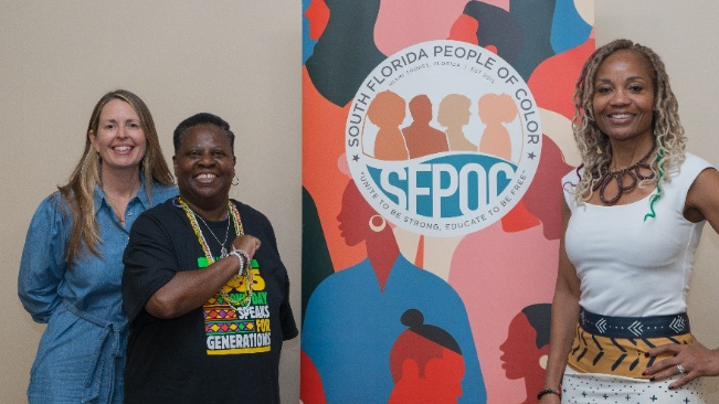 A group of people standing in front of a poster

AI-generated content may be incorrect.