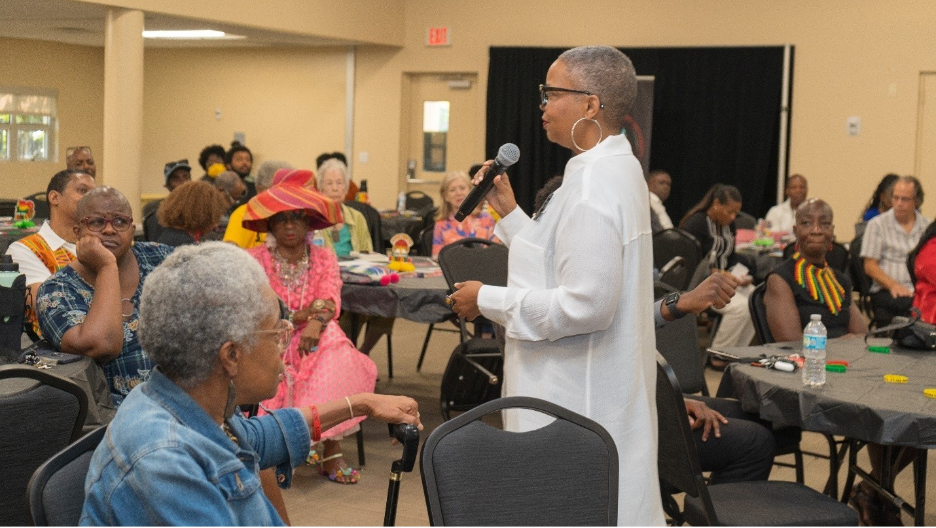 A person speaking into a microphone

AI-generated content may be incorrect.